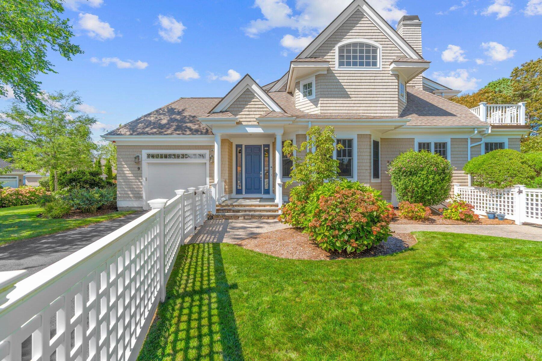 9 Vineyard Reach Mashpee, MA 02649 - Photo 1 of 60 a front view of a house with a garden