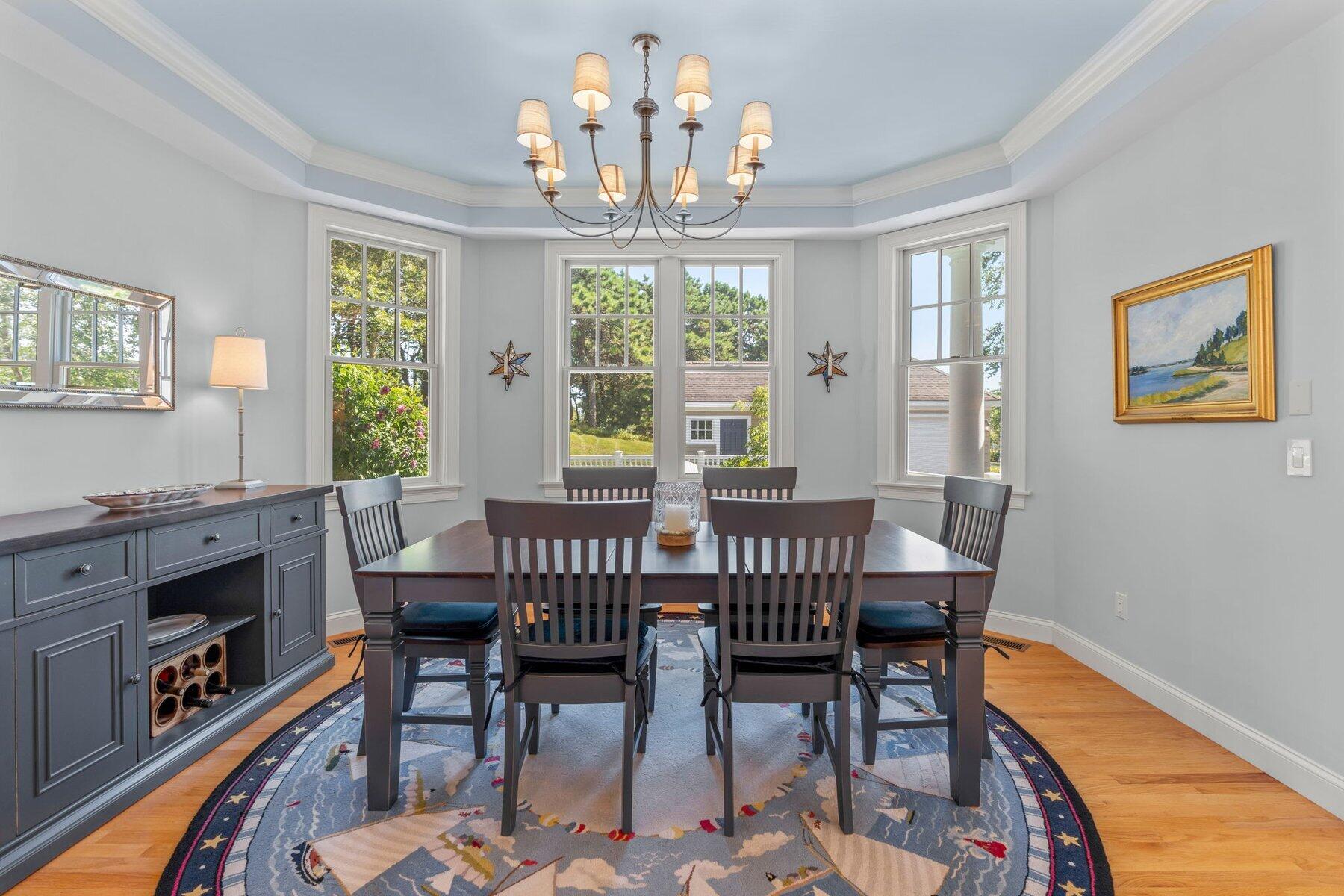 9 Vineyard Reach Mashpee, MA 02649 - Photo 23 of 60 a view of a dining room with furniture a chandelier and wooden floor