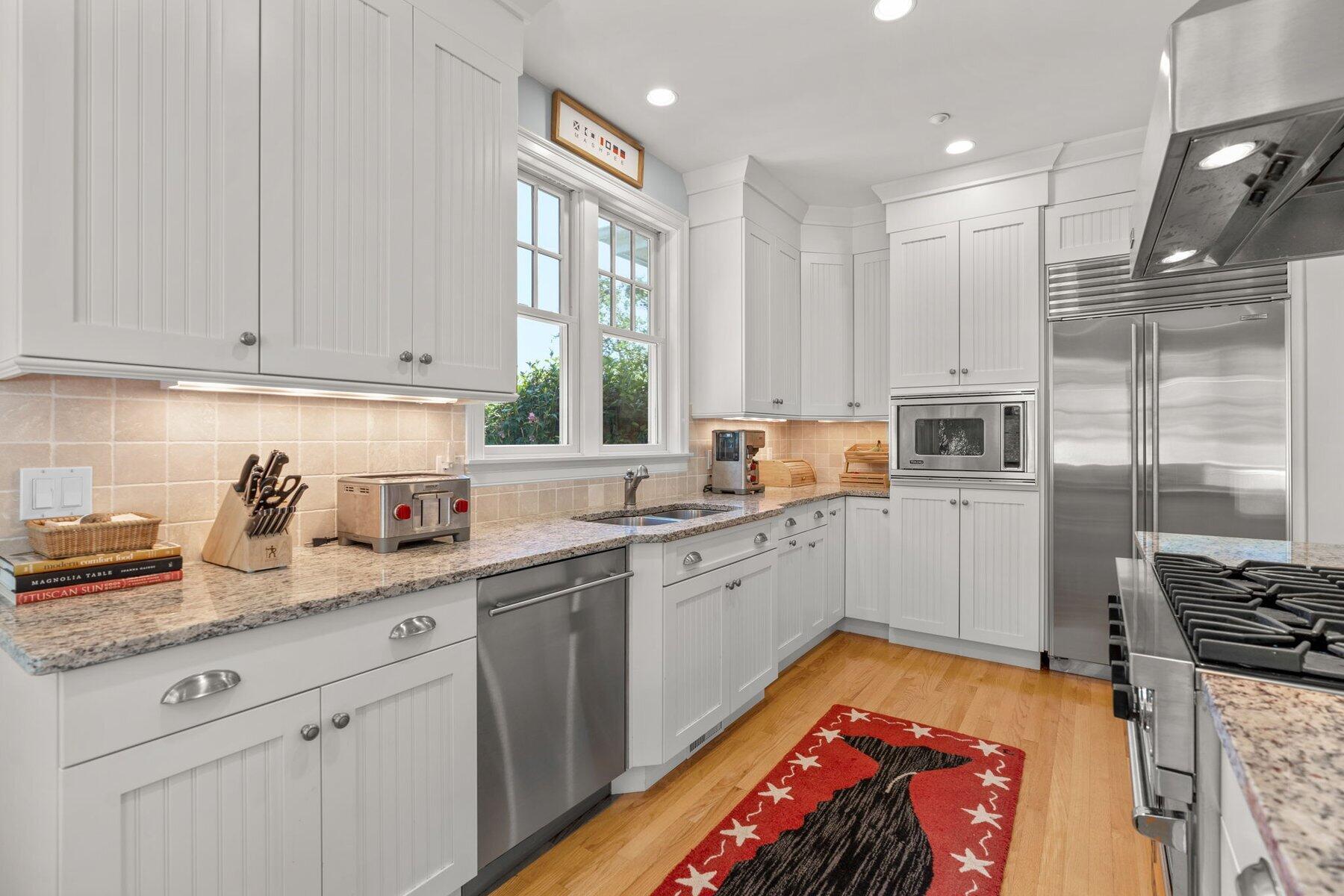 9 Vineyard Reach Mashpee, MA 02649 - Photo 30 of 60 a kitchen with granite countertop a sink stainless steel appliances and cabinets