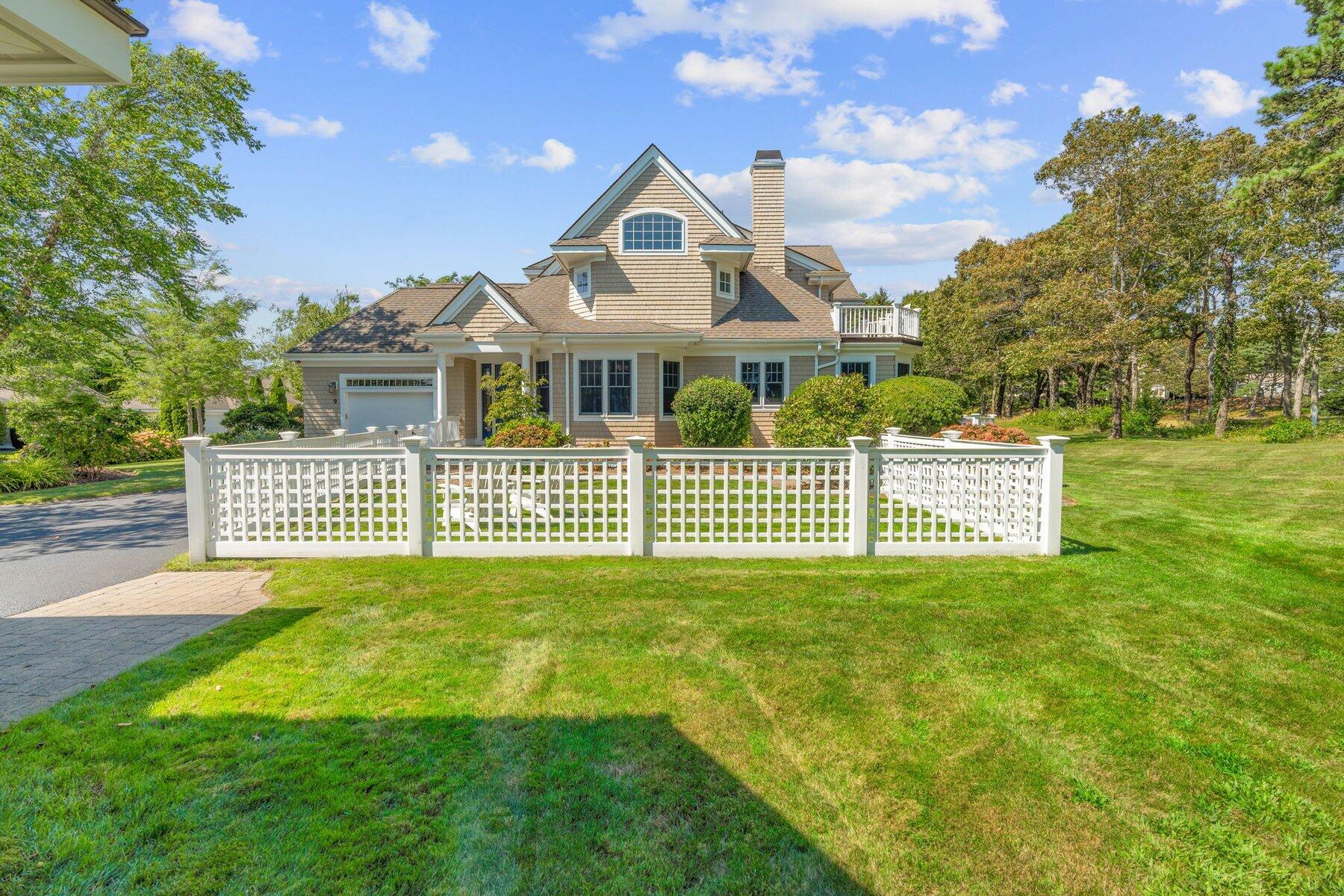 9 Vineyard Reach Mashpee, MA 02649 - Photo 3 of 60 a front view of a house with a yard