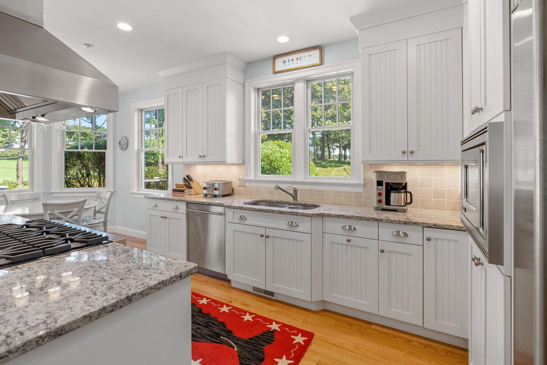9 Vineyard Reach Mashpee, MA 02649 - Photo 32 of 60 a kitchen with stainless steel appliances granite countertop a sink stove and cabinets