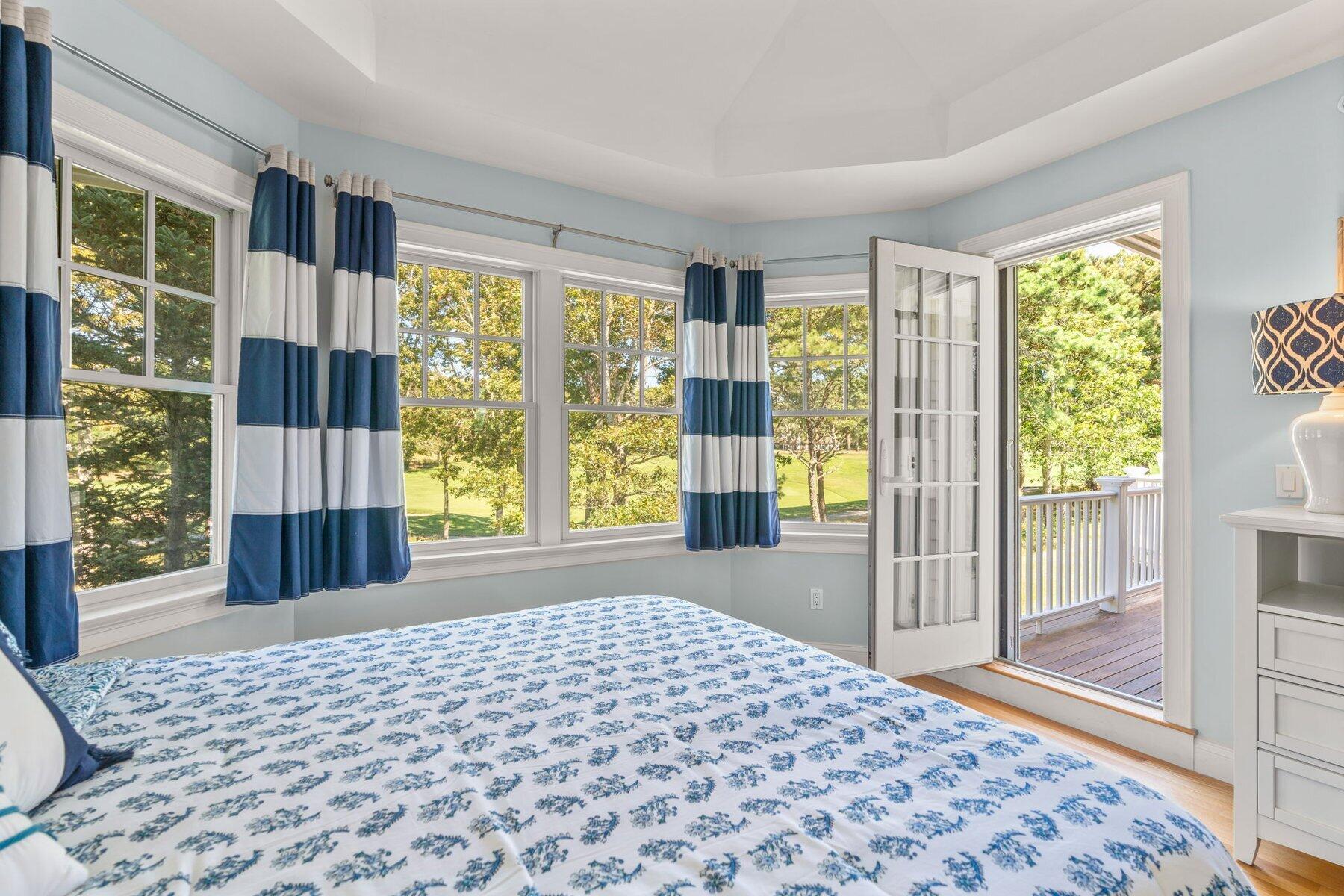 9 Vineyard Reach Mashpee, MA 02649 - Photo 39 of 60 a bedroom with a bed and wooden floor