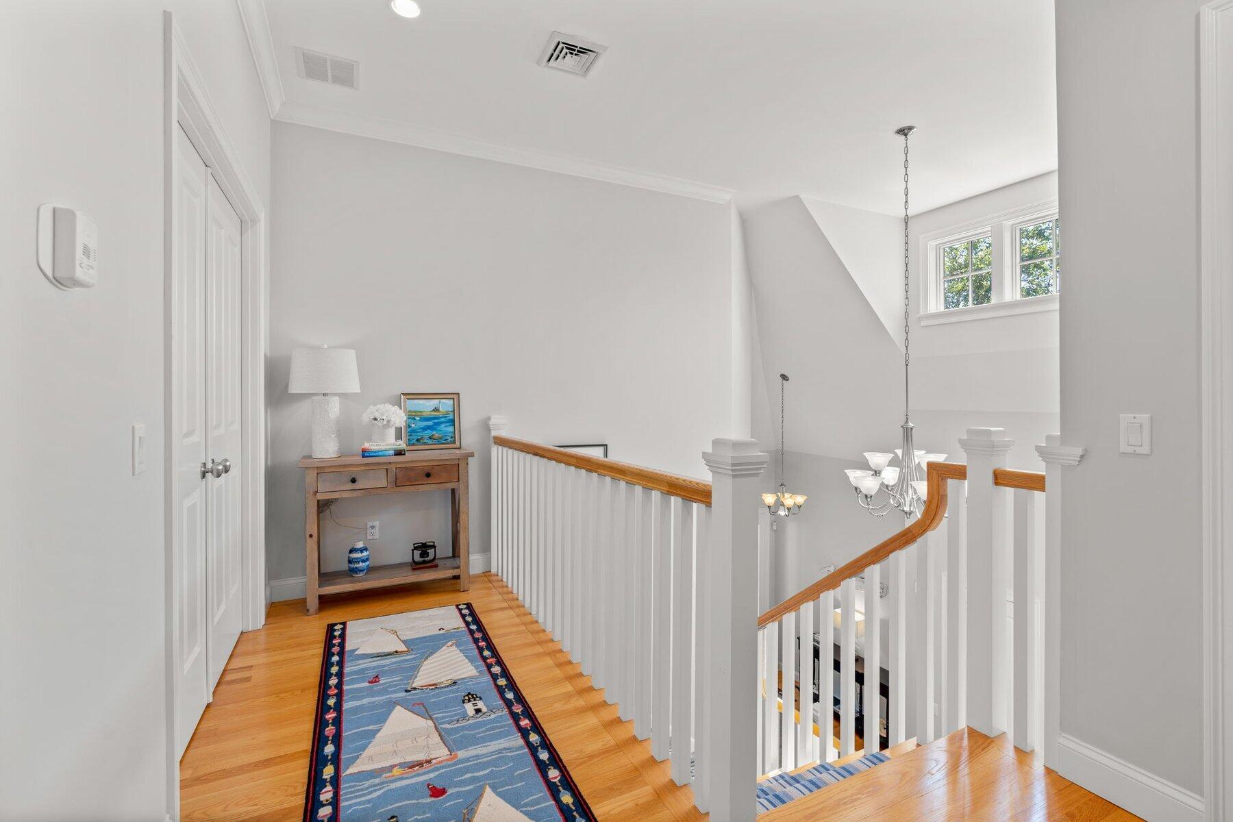 9 Vineyard Reach Mashpee, MA 02649 - Photo 41 of 60 a view of hallway with furniture and wooden floor
