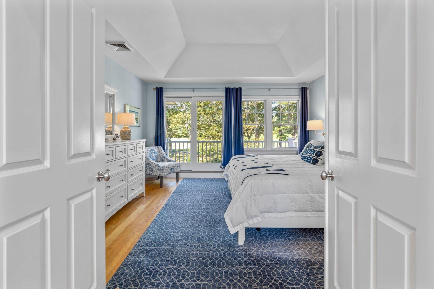 9 Vineyard Reach Mashpee, MA 02649 - Photo 42 of 60 a spacious bedroom with a bed and a large window