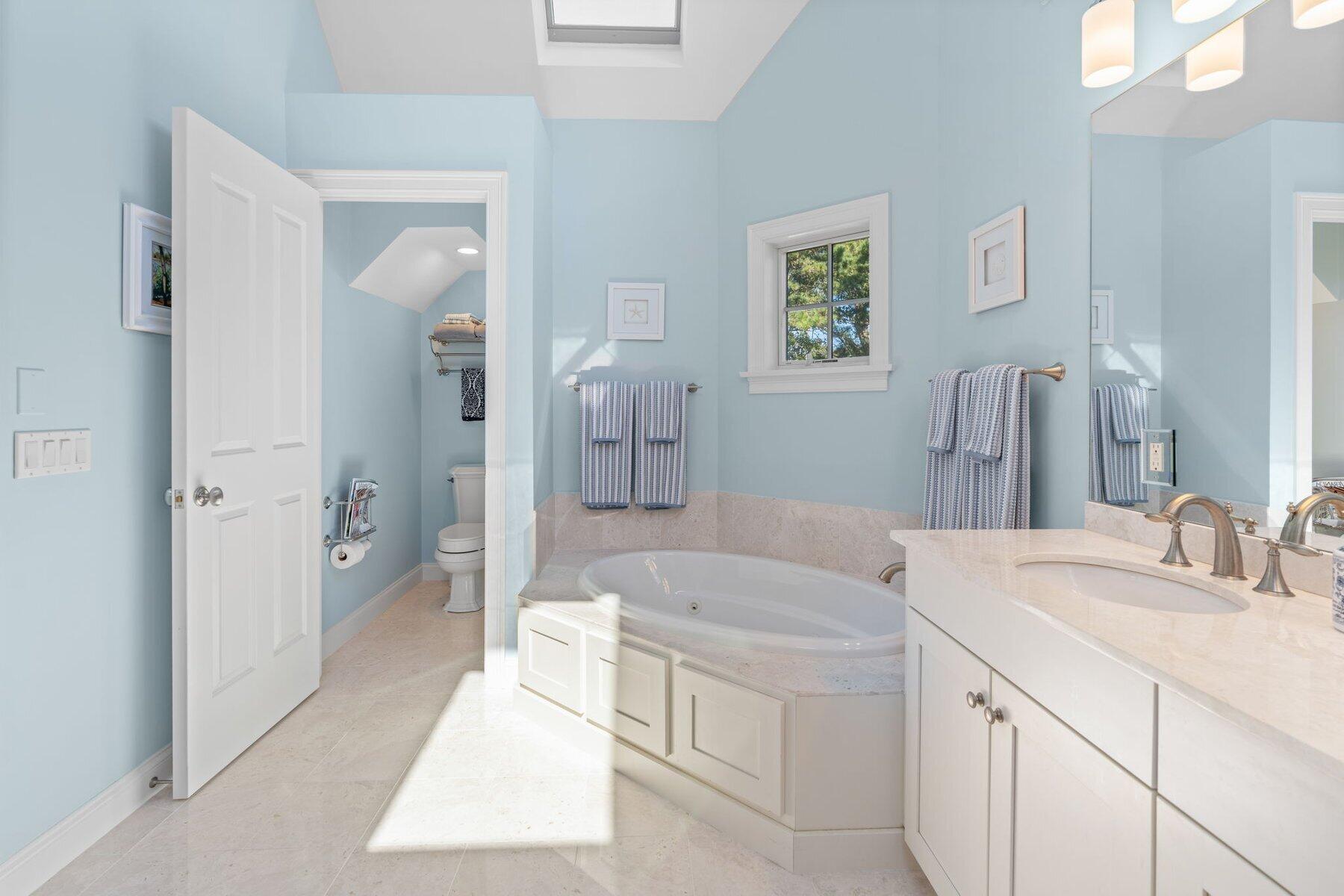 9 Vineyard Reach Mashpee, MA 02649 - Photo 46 of 60 a spacious bathroom with a tub sink and mirror