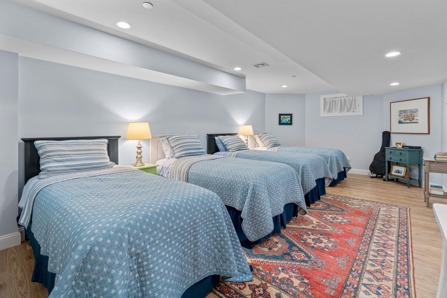 9 Vineyard Reach Mashpee, MA 02649 - Photo 54 of 60 a bedroom with two beds and a lamp