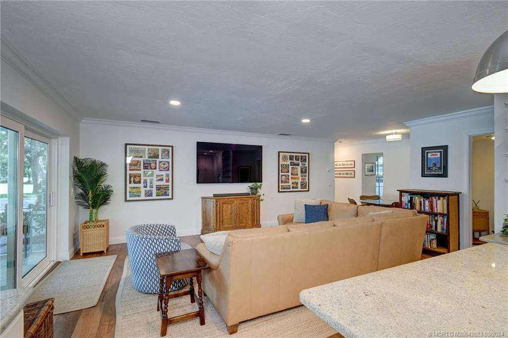 5 Banyan Road Stuart, FL 34996 - Photo 11 of 49 a living room with furniture a flat screen tv and a refrigerator