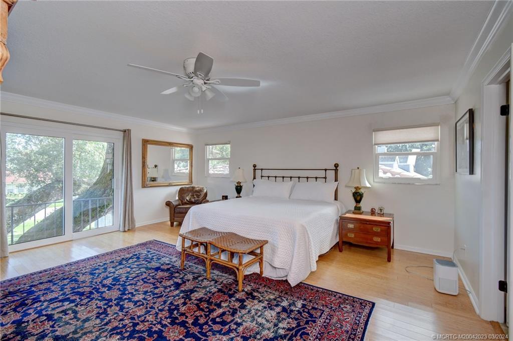 5 Banyan Road Stuart, FL 34996 - Photo 18 of 49 a bedroom with a bed and a lamp next to a window