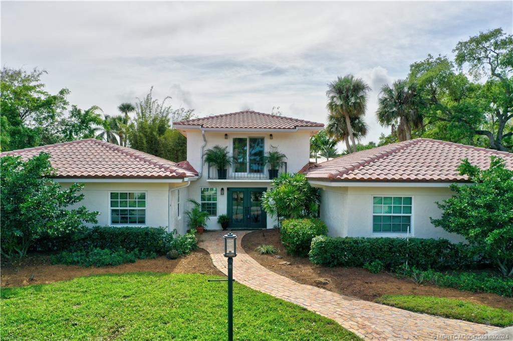 5 Banyan Road Stuart, FL 34996 - Photo 2 of 49 a front view of a house with garden
