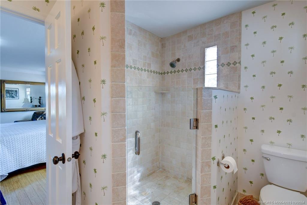 5 Banyan Road Stuart, FL 34996 - Photo 21 of 49 a bathroom with a toilet and shower