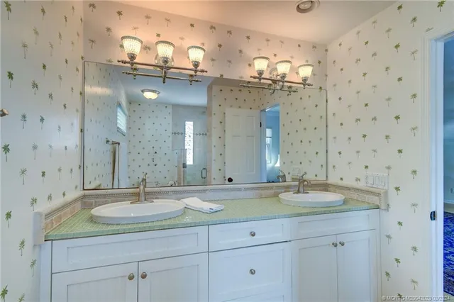 a bathroom with a sink double vanity and a mirror