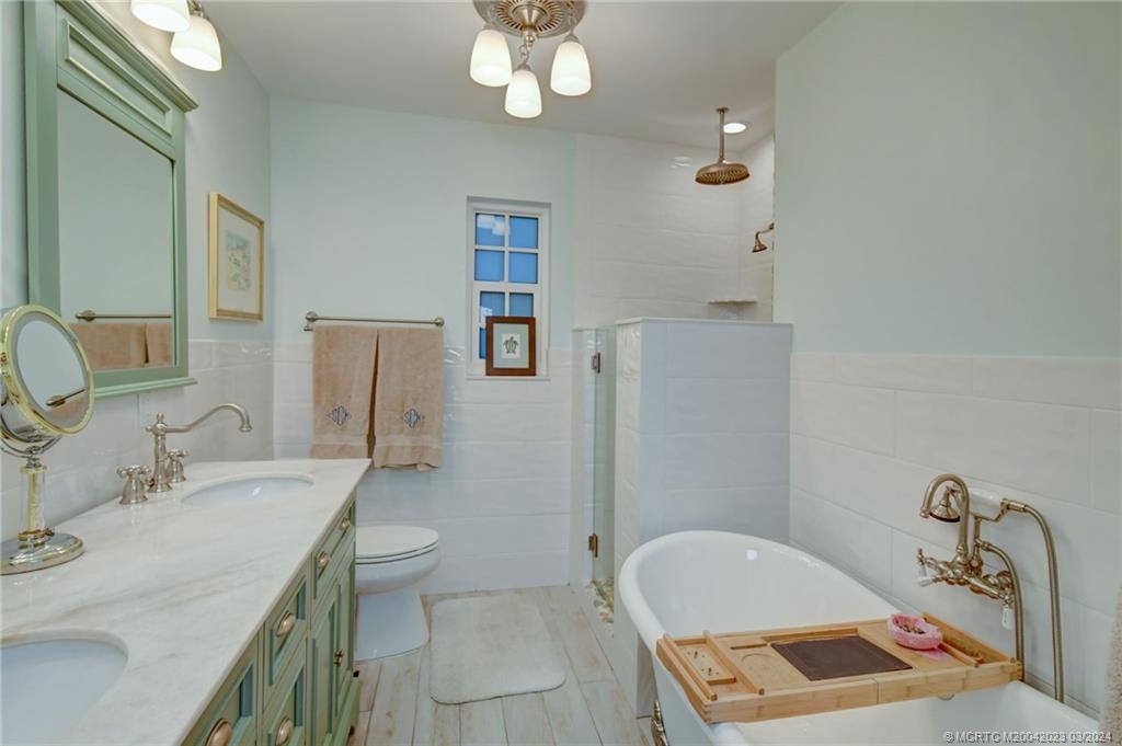 5 Banyan Road Stuart, FL 34996 - Photo 25 of 49 a bathroom with a sink a toilet and shower