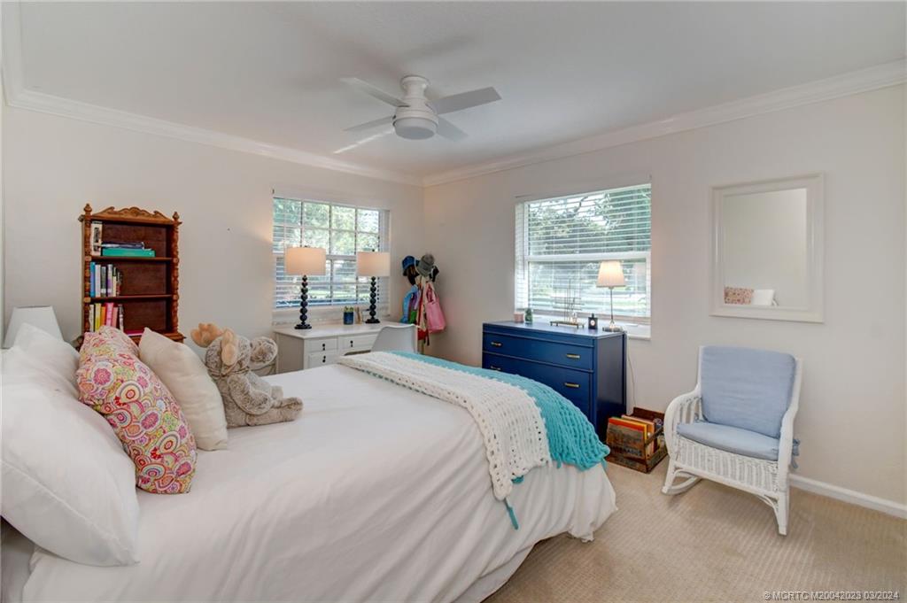 5 Banyan Road Stuart, FL 34996 - Photo 26 of 49 a bedroom with a bed and a couch