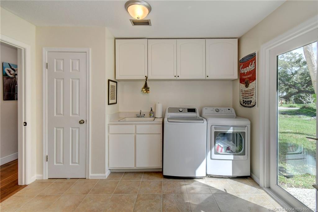 5 Banyan Road Stuart, FL 34996 - Photo 30 of 49 a utility room with dryer and washer