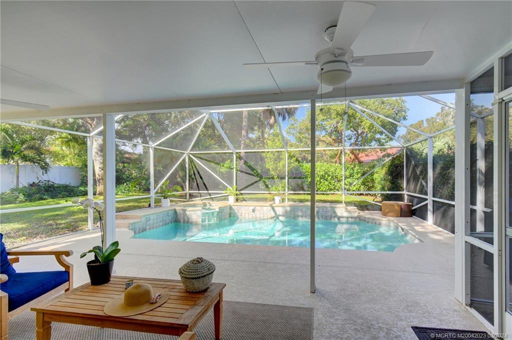 5 Banyan Road Stuart, FL 34996 - Photo 32 of 49 a view of a living room and porch with furniture and garden view