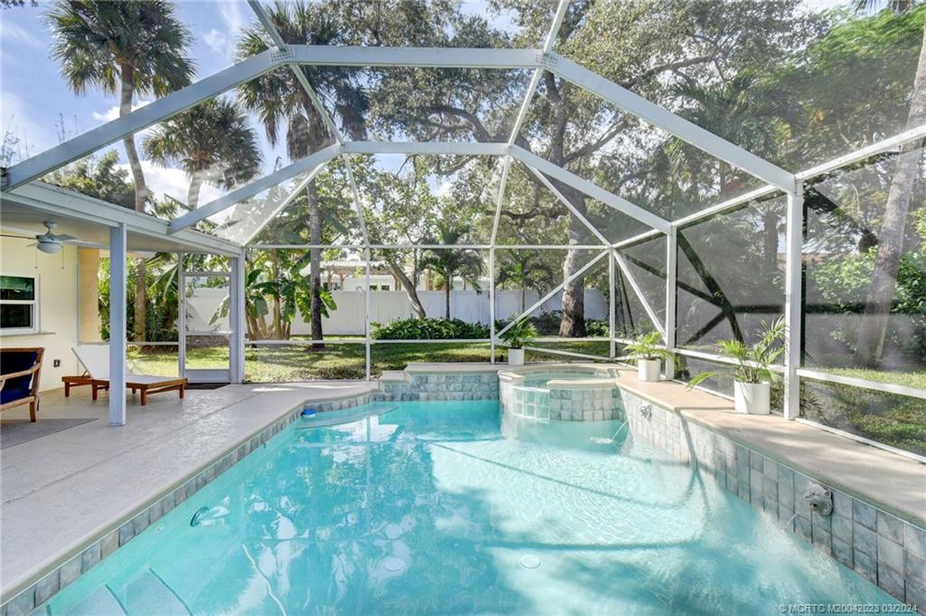 5 Banyan Road Stuart, FL 34996 - Photo 34 of 49 a view of a swimming pool with a patio and a yard