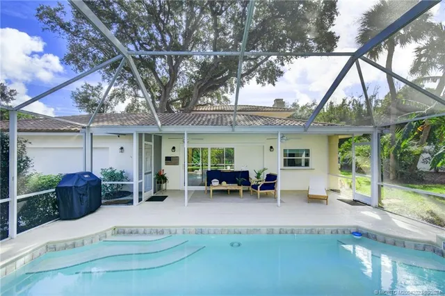 a view of a backyard with swimming pool