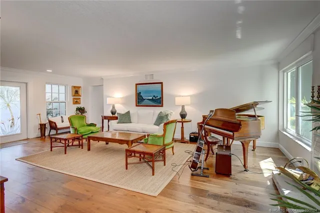a living room with furniture a rug and a window
