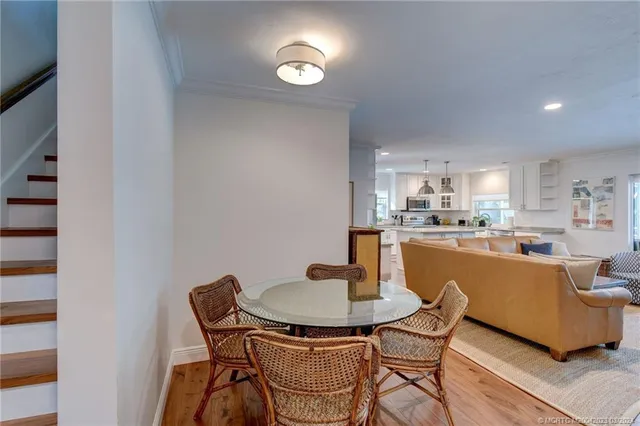 a dining room with furniture and wooden floor