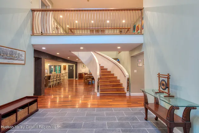 a view of entryway and hall with wooden floor