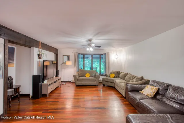 a living room with fireplace furniture and a flat screen tv