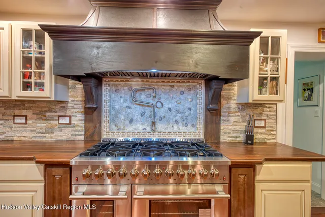 a stove top oven sitting inside of a kitchen