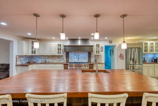 a kitchen with a table chairs and a view of living room