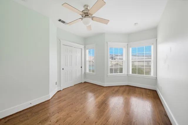a view of a room with a fan and a window