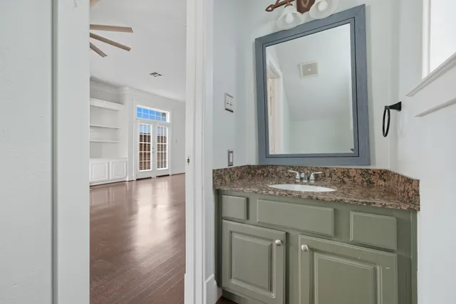 a spacious bathroom with double sink and a large mirror