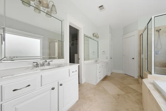 a spacious bathroom with a tub shower and sink