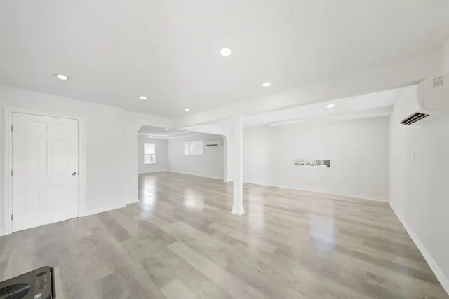a view of a room with wooden floor