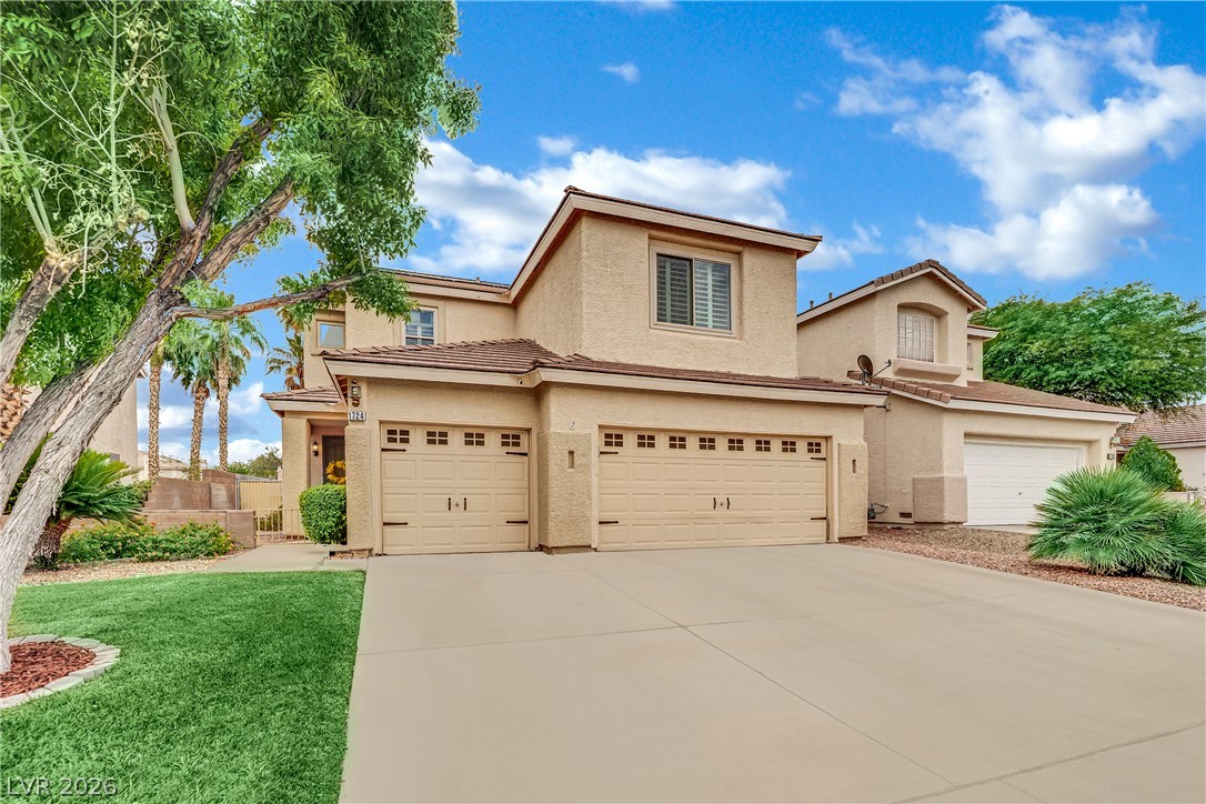 1724 Millstream Way Henderson, NV 89074 - Photo 4 of 60 A traditional stucco exterior with an attached garage and neatly kept front yard invites gracious living.