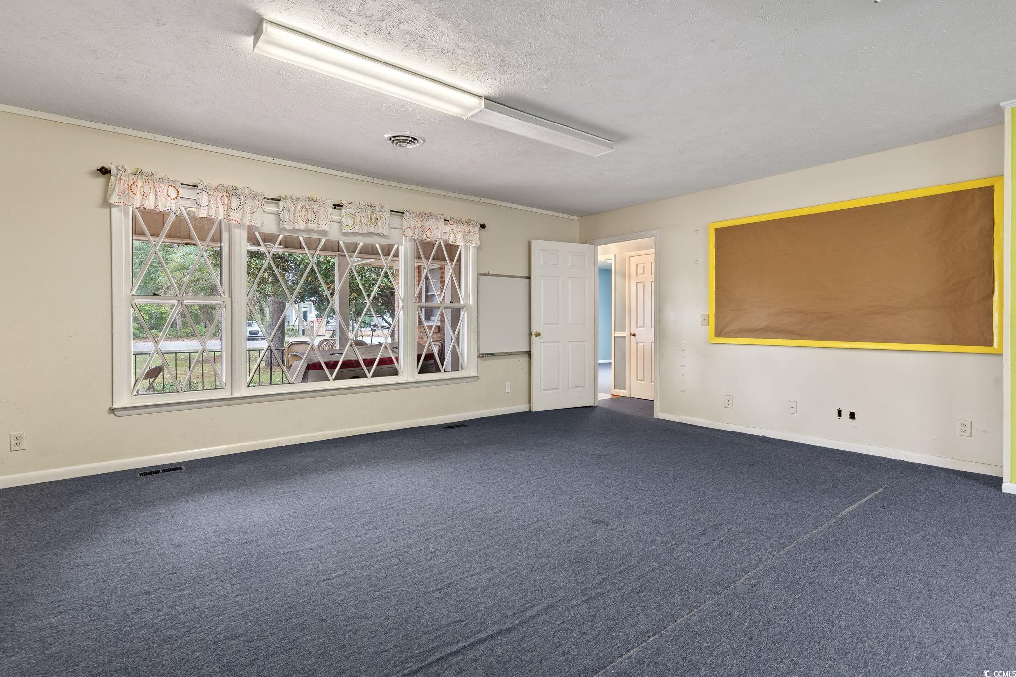 813 Bellamy Road North Myrtle Beach, SC 29582 - Photo 11 of 29 Unfurnished room featuring a textured ceiling and