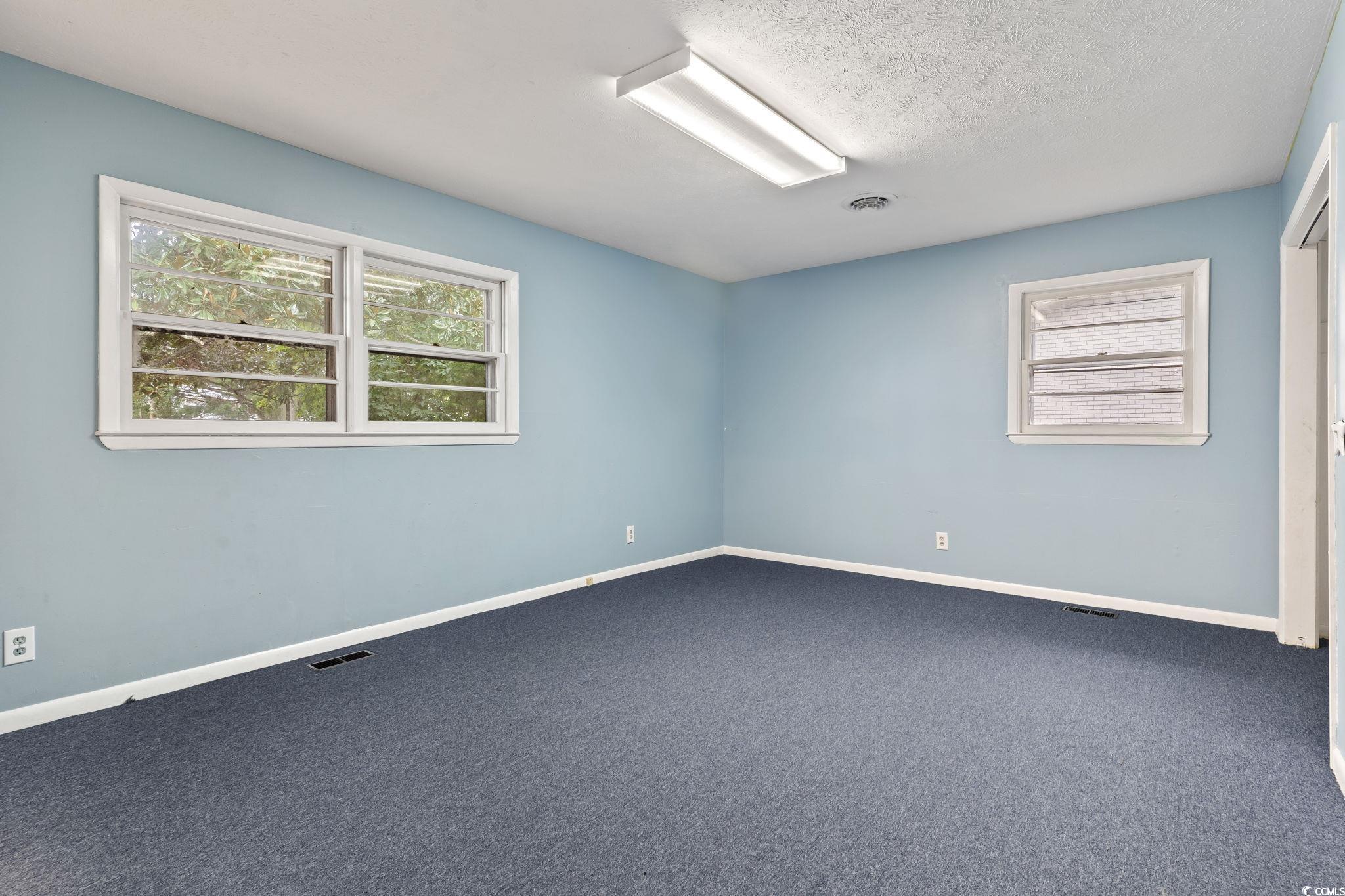 813 Bellamy Road North Myrtle Beach, SC 29582 - Photo 14 of 29 Carpeted spare room featuring a textured ceiling