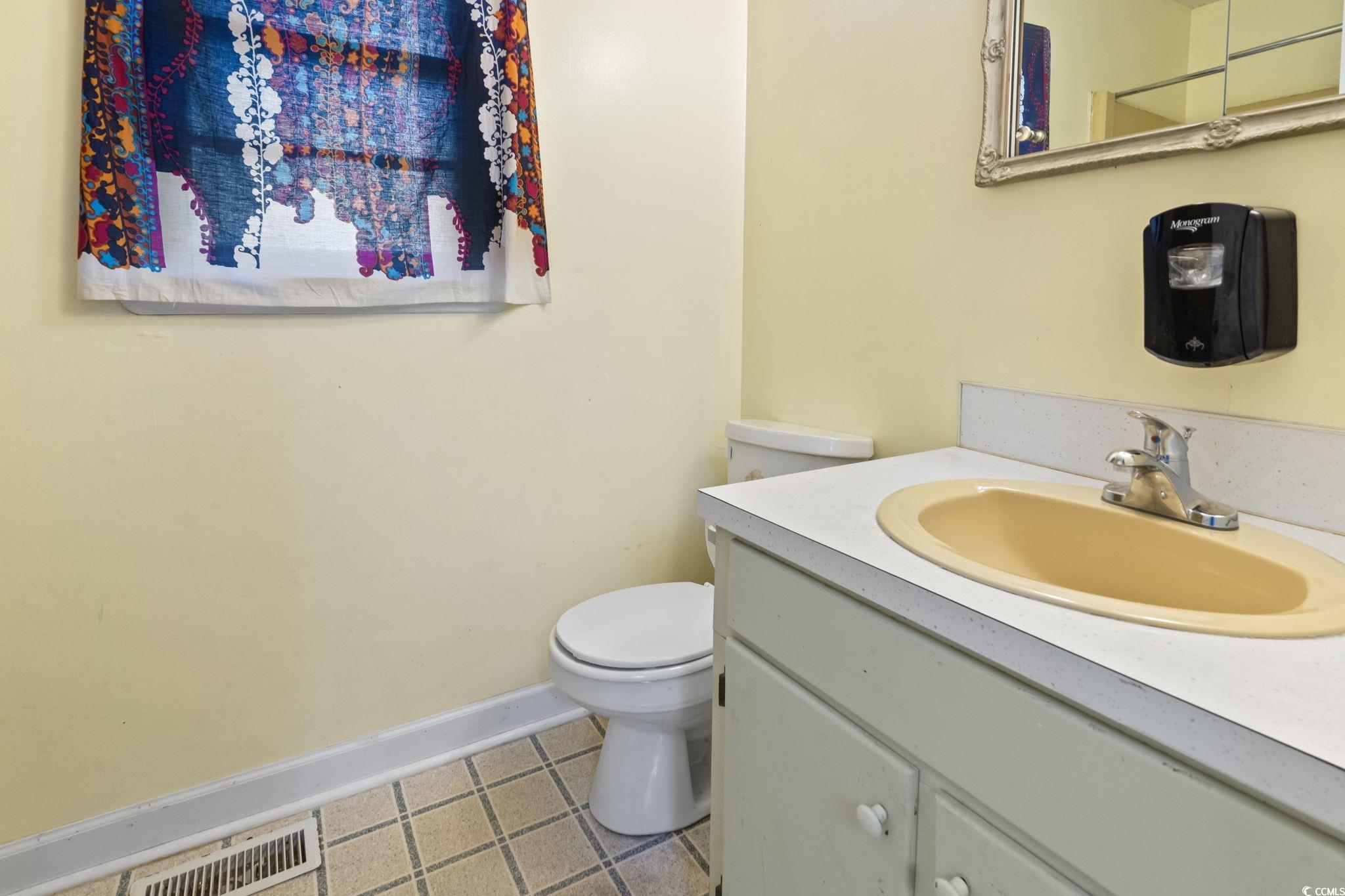 813 Bellamy Road North Myrtle Beach, SC 29582 - Photo 15 of 29 Bathroom featuring vanity and toilet