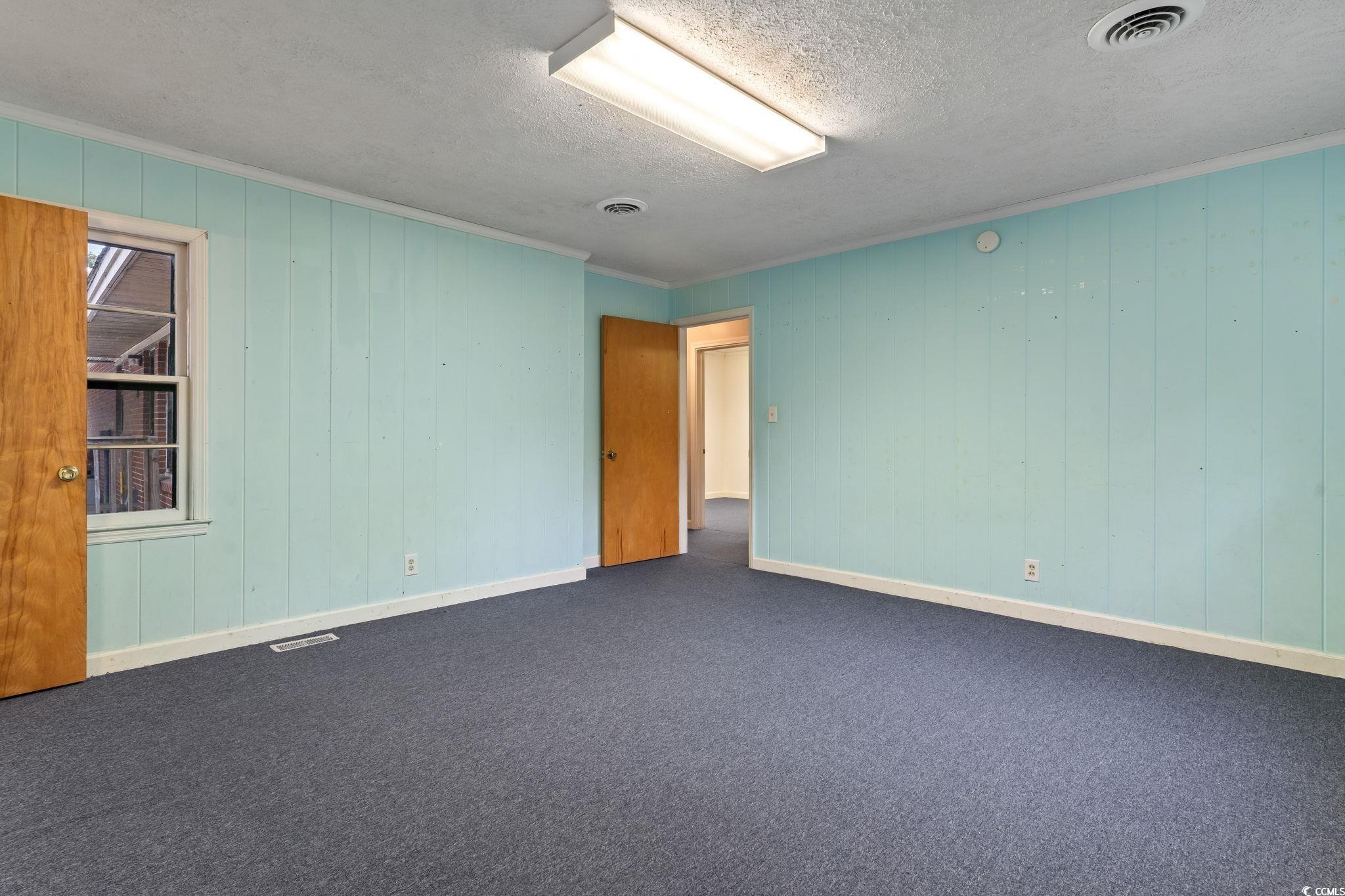 813 Bellamy Road North Myrtle Beach, SC 29582 - Photo 18 of 29 featuring crown molding, a textured ceiling, wood