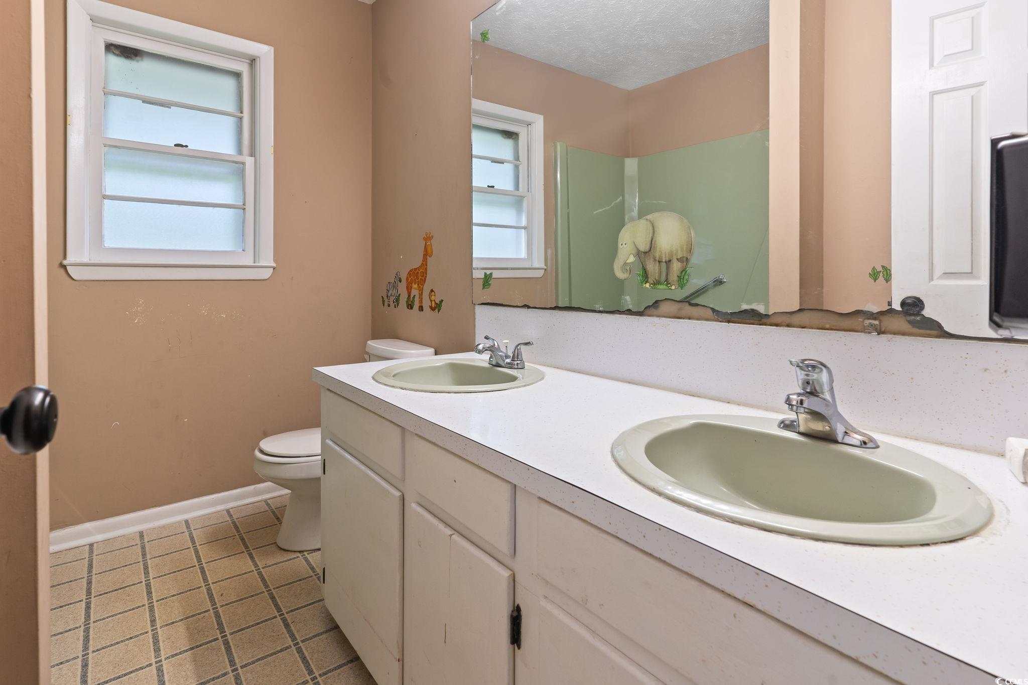 813 Bellamy Road North Myrtle Beach, SC 29582 - Photo 21 of 29 Bathroom with a healthy amount of sunlight, tile p