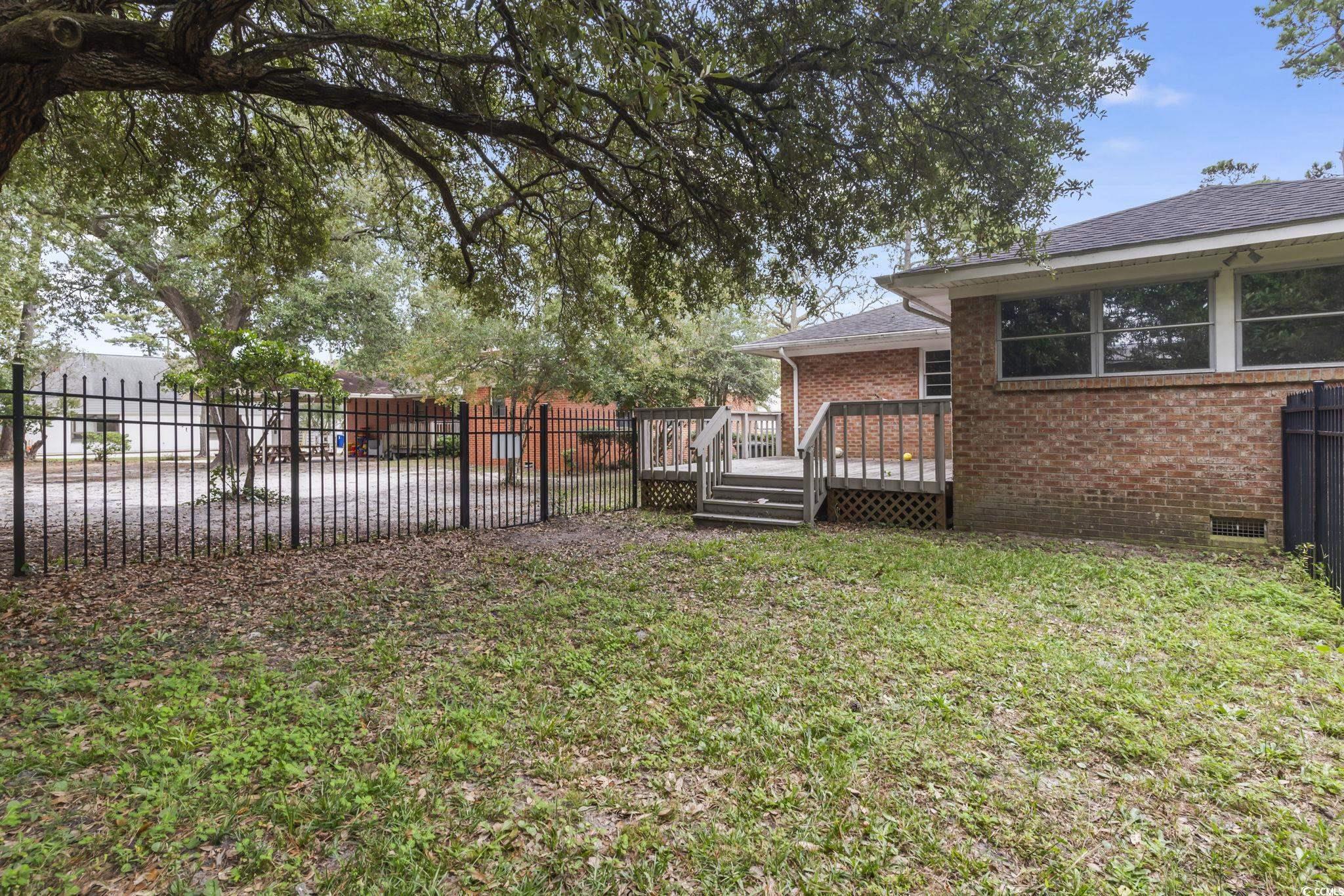 813 Bellamy Road North Myrtle Beach, SC 29582 - Photo 25 of 29 View of yard featuring a deck