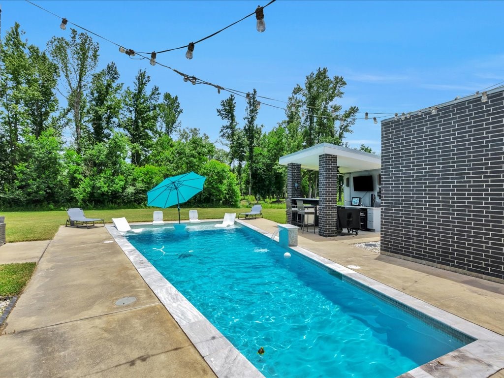 a view of a swimming pool with a patio