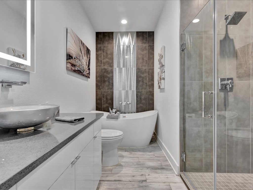 129 White Oak Loop Lufkin, TX 75901 - Photo 11 of 50 a bathroom with a granite countertop sink a toilet a mirror and shower
