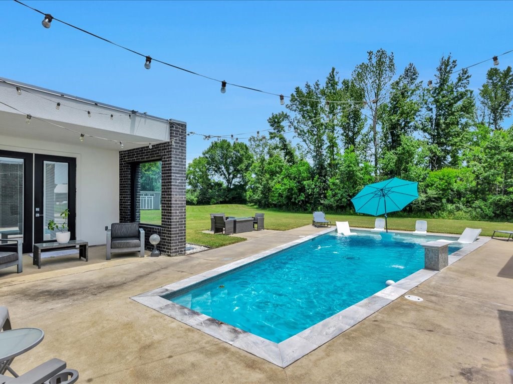129 White Oak Loop Lufkin, TX 75901 - Photo 43 of 50 a view of a swimming pool with a patio