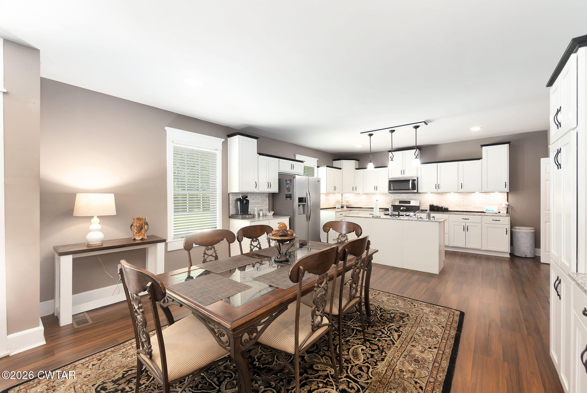 554 East Main Street Jackson, TN 38301 - Photo 15 of 60 a open dining room with kitchen island stainless steel appliances furniture a large window and a kitchen view