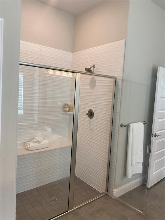 209 Johnson Street Granbury, TX 76048 - Photo 30 of 40 Bathroom with tile flooring and a shower with door