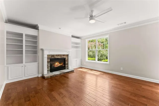 an empty room with windows and a fireplace