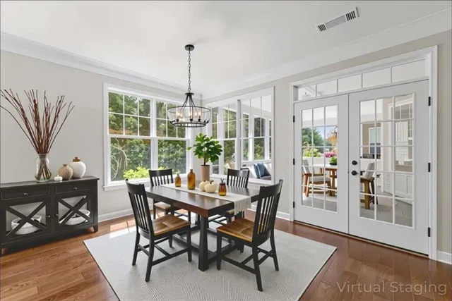 a view of a dining room with furniture window and wooden floor