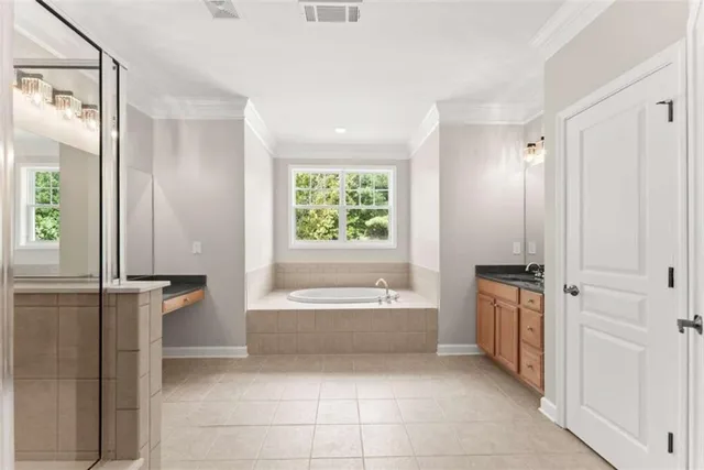 a bathroom with a glass shower door and a sink