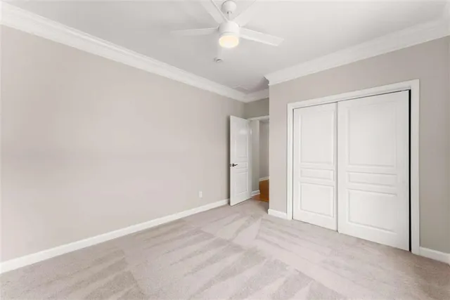 a view of an empty room with a ceiling fan