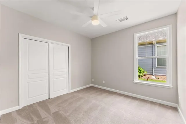 a living room with furniture a chandelier and a potted plant