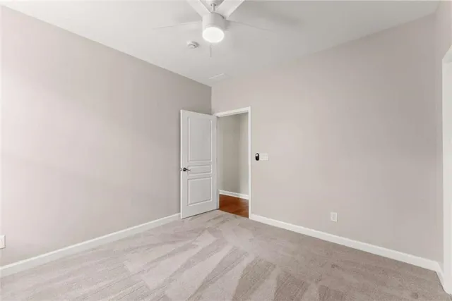 a view of an empty room with a fireplace and large windows
