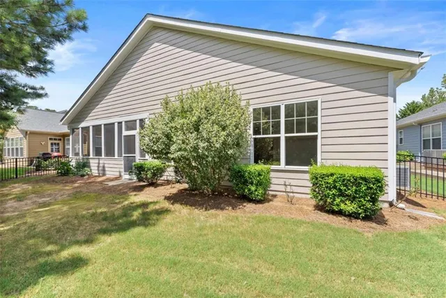 an aerial view of a house with a garden and lake view